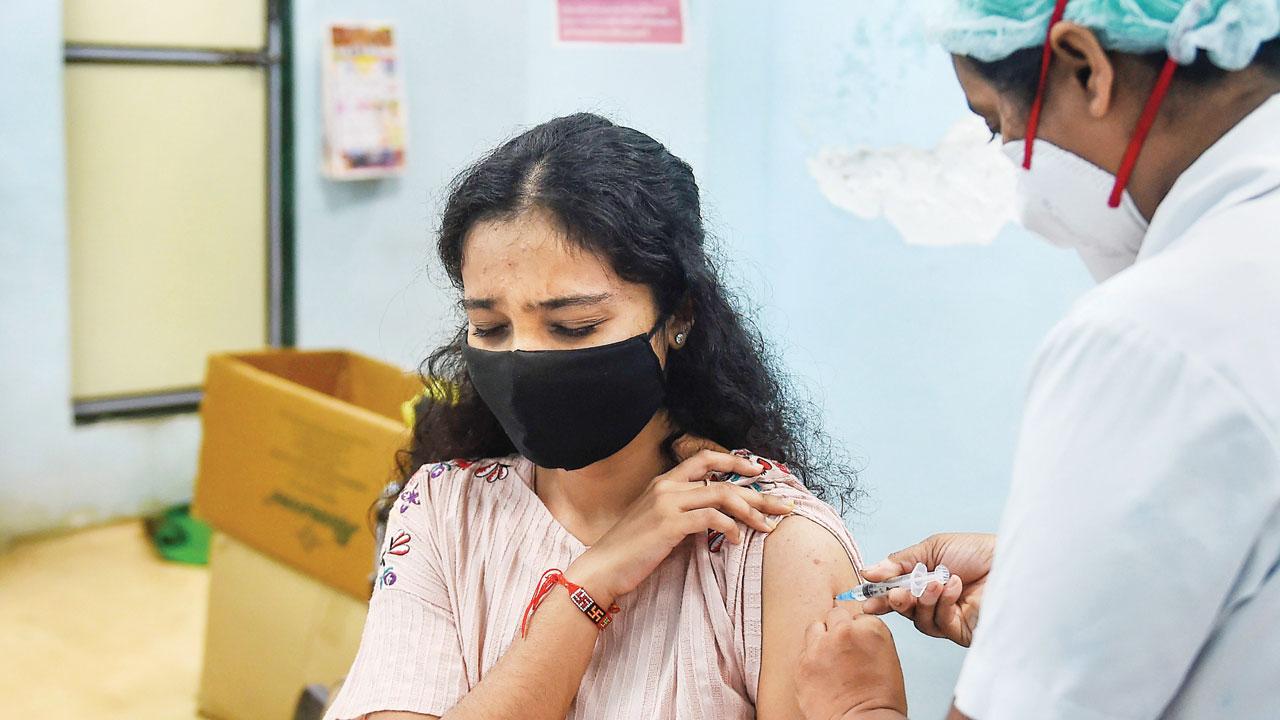 A medic inoculates a beneficiary during a special vaccination drive for teachers and students in Mumbai, on Tuesday. Pic/PTI