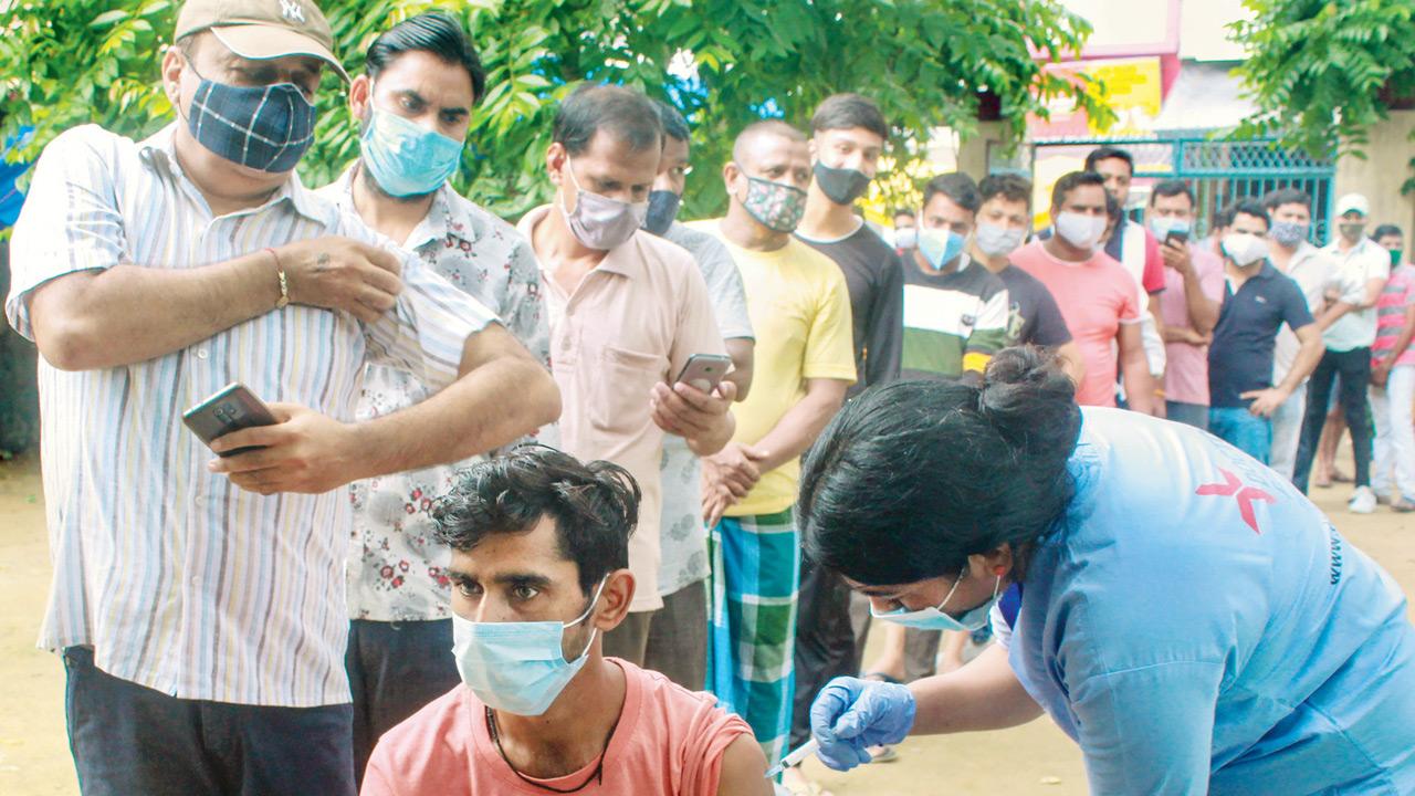 A health worker administers a dose of Covid-19 vaccine to a beneficiary at a camp in Gurugram, on Sunday. Pics/PTI