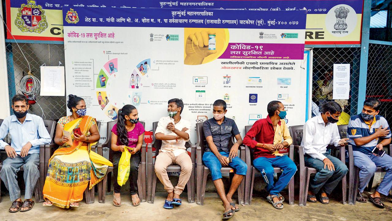 People wait to receive a Covid-19 vaccine at a hospital in Mumbai on Tuesday. Pic/AFP