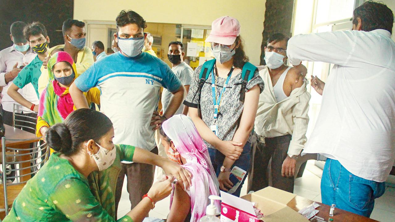 A health worker administers a Covid-19 vaccine dose to a beneficiary, at a vaccination centre, in Gurugram, on Tuesday. Pic/PTI