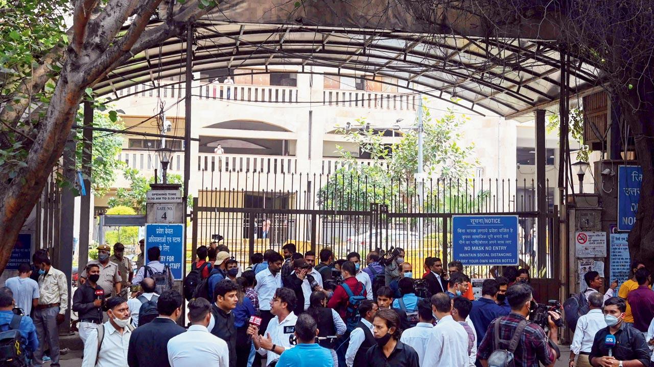 People gather outside the entrance to the Rohini district courtroom after the shootout. Pic/AFP