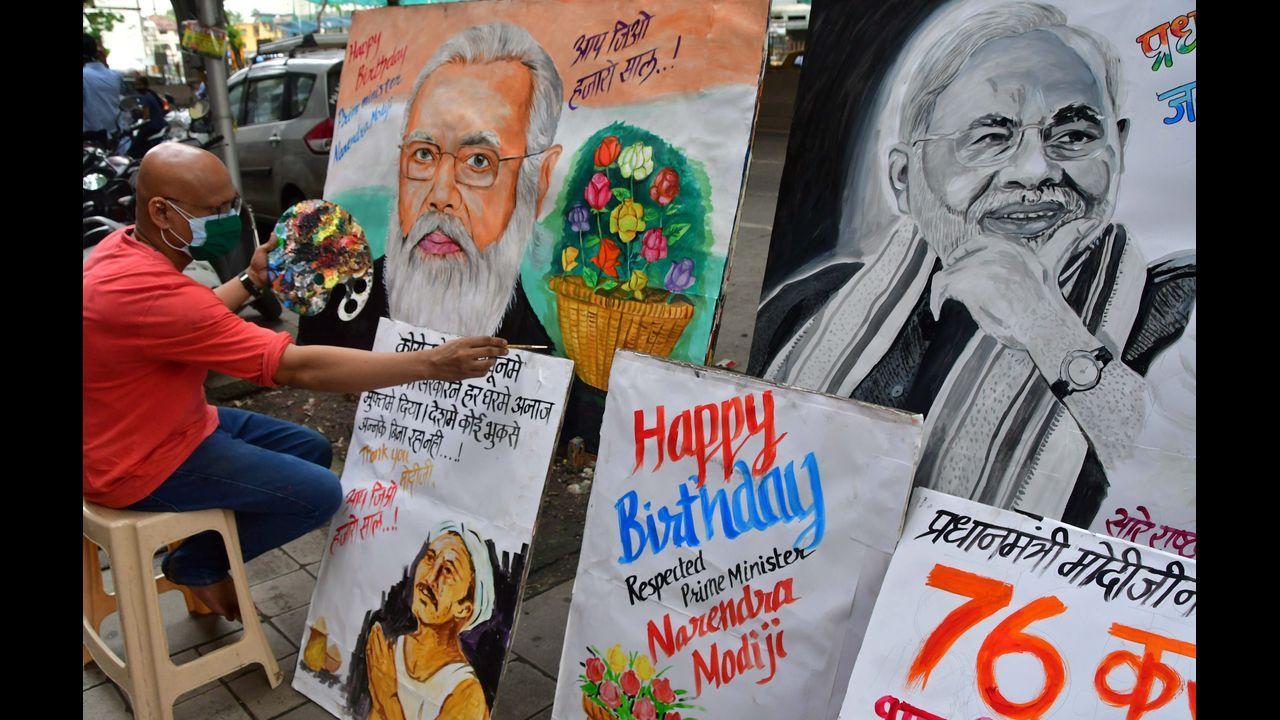 Artists make paintings of PM Narendra Modi to wish him on his birthday, at Lalbaug, in Mumbai. Pic/PTI