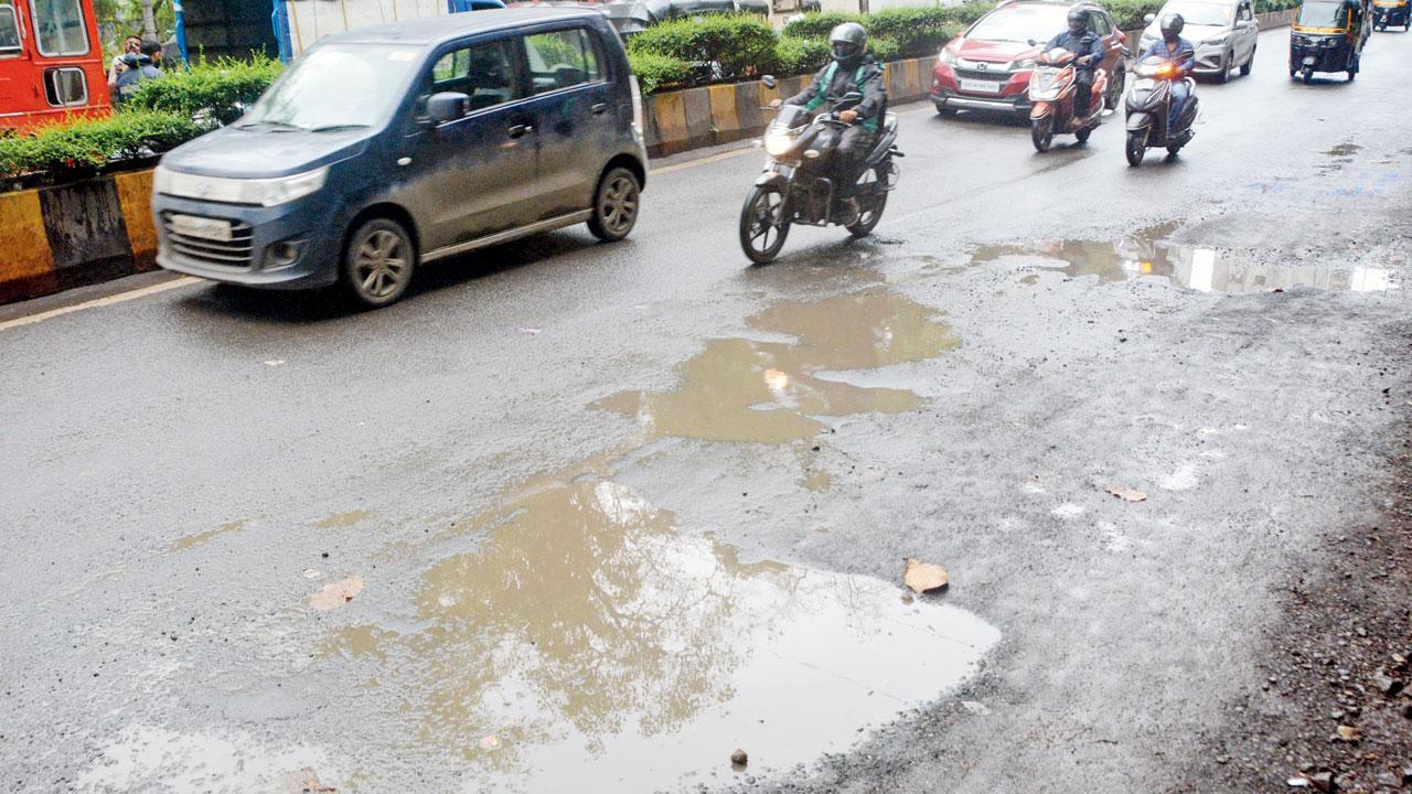 Motorists stay away from potholes on a road inside the Aarey Milk Colony on Monday. Pic/Satej Shinde