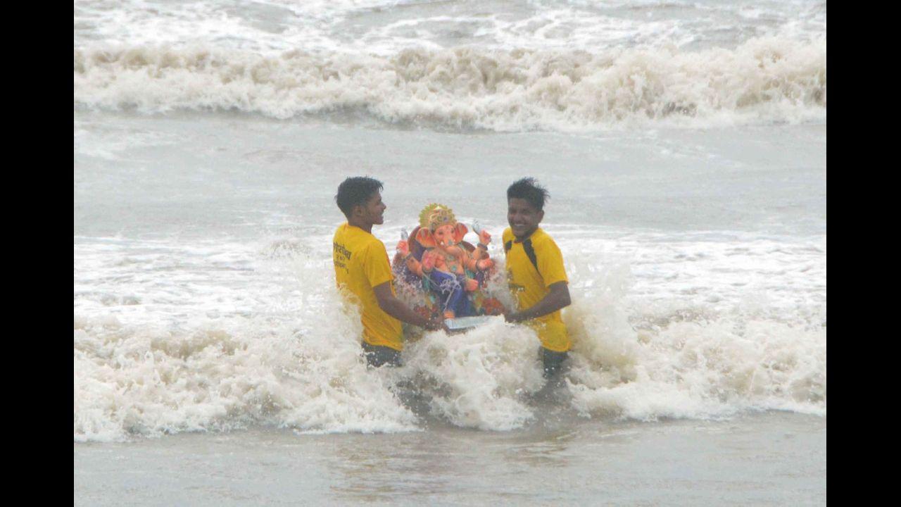 IN PHOTOS: First day of Ganpati idol immersion in Mumbai remains low-ley