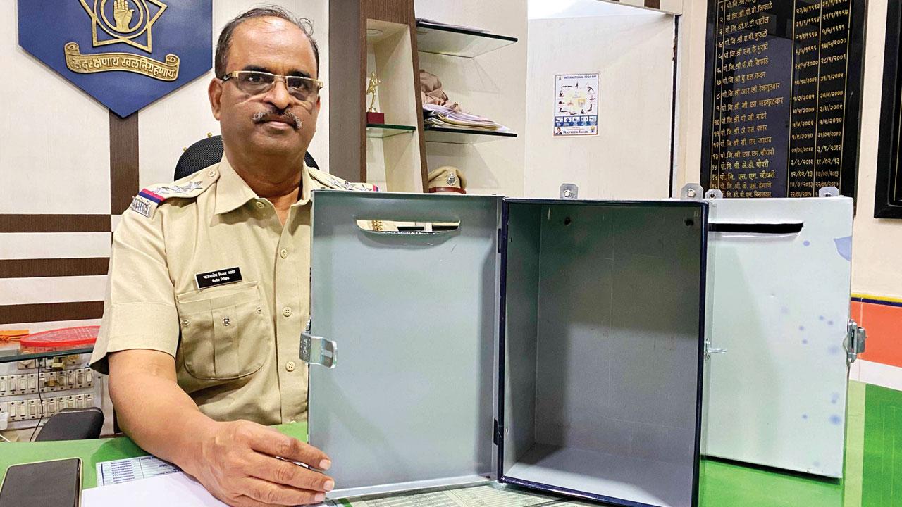 Senior Police Inspector Bhausaheb Ahir shows the Women/Children Complaint Box