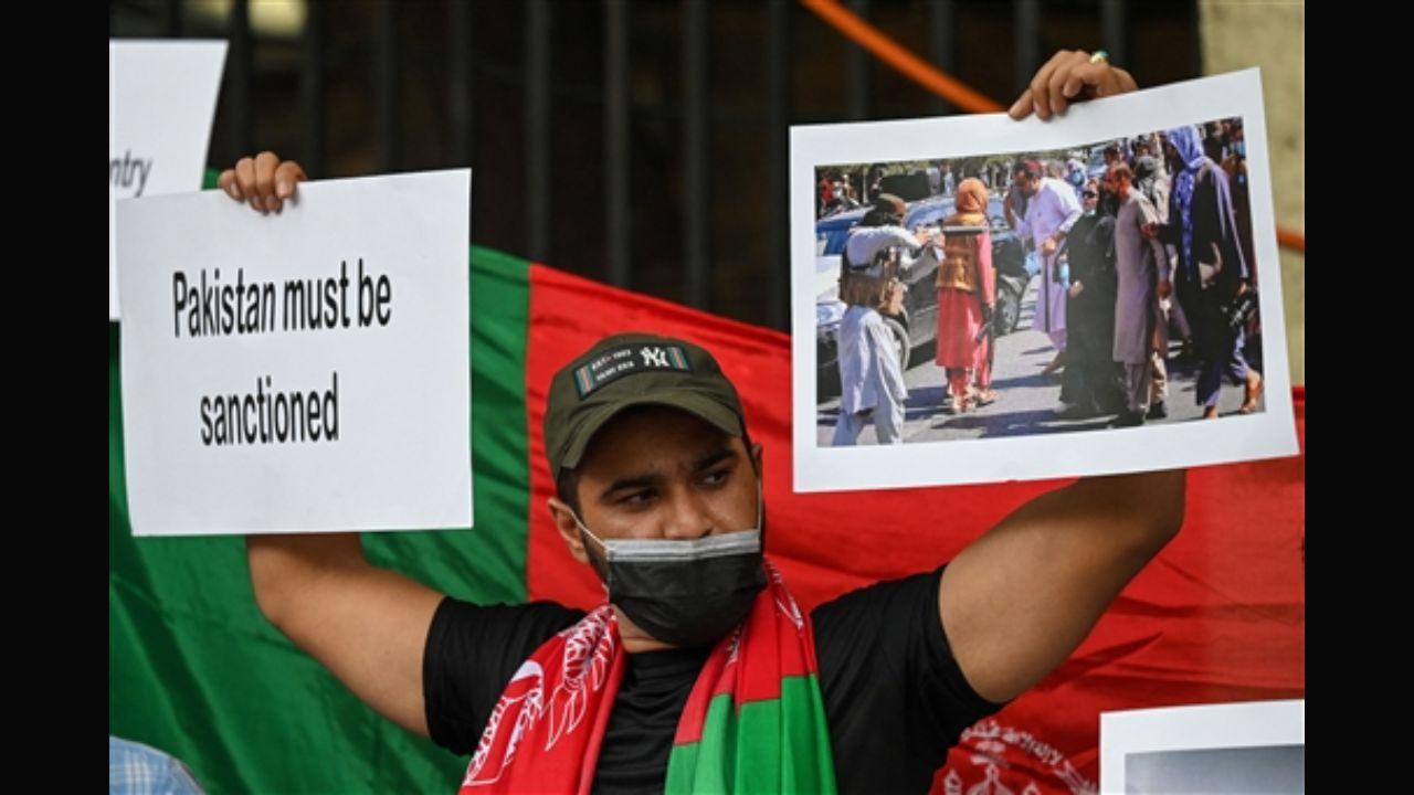 A man holding a placard wants sanctions against Pakistan. According to reports, the Pakistan govt is covertly helping the Taliban govt in Afghanistan. Pakistan PM Imran Khan had said Afghans have broken 'shackles of slavery' after the fall of the Ashraf Ghani dispensation. Pic/AFP