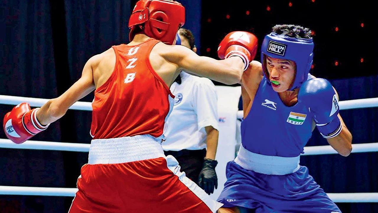 The shining six pack! India’s Bishwamitra Chongtham (right) battles with Uzbek’s Kuziboev Ahmadjon during the 51kg final