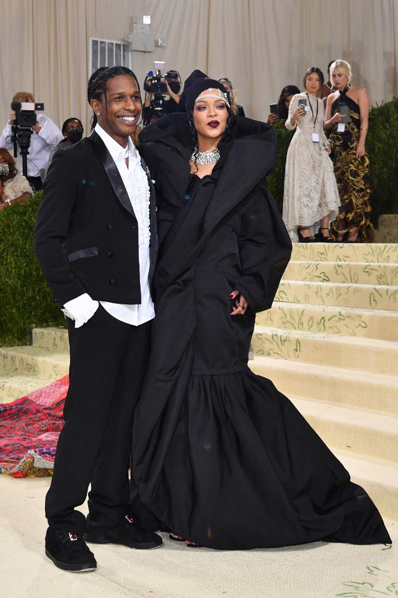Rihanna and A$AP Rocky stole the show as they arrived together, marking their red carpet debut at the Met Gala 2021. Rihanna was dressed in a gigantic sculptural coat dress, featuring a high collar and flared hem, while A$AP Rocky wrapped himself in a multicolour quilted blanket look.
