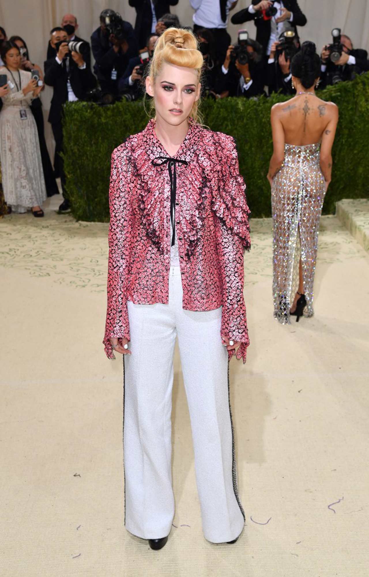 Kristen Stewart made a fashionable appearance at the 2021 Met Gala, rocking an edgy and stylish outfit. The actor graced the Met carpet in a pink Chanel jacket and white pants that were everything fans hoped for and more.
