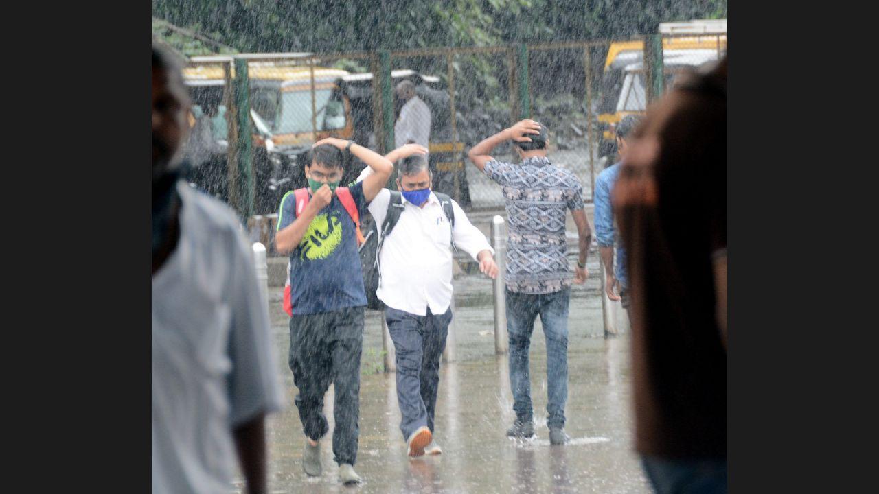 Mumbaikars getting on with their daily activities amidst heavy rainfall in the city.
