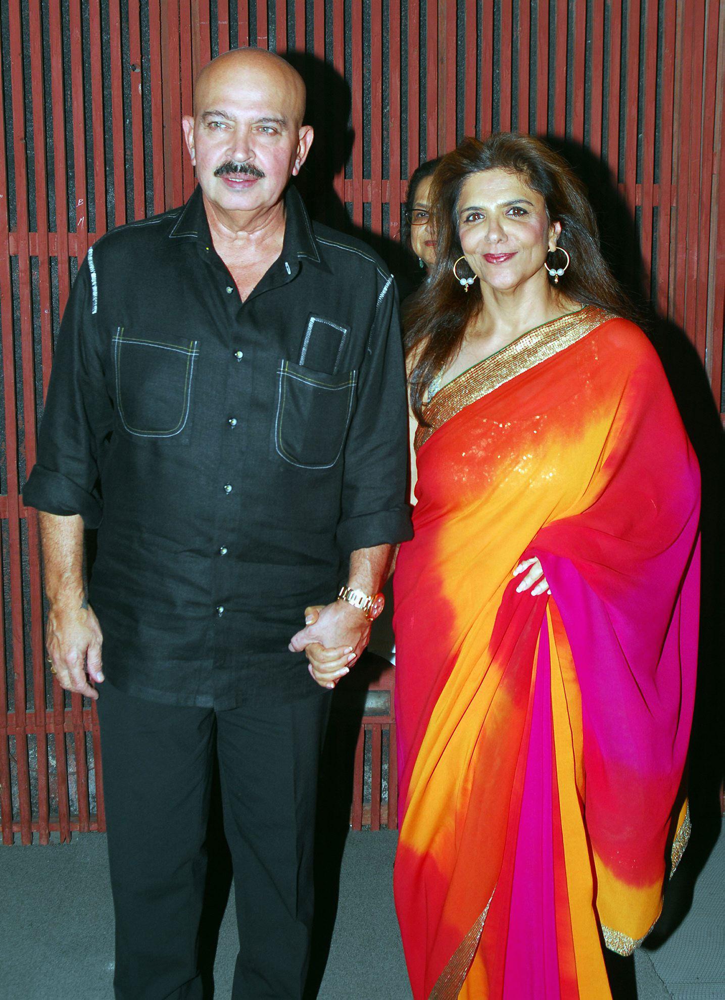 Let's take a look at a few more candid pictures of Rakesh Roshan. Rakesh Roshan and Pinky Roshan hand-in-hand. Pinky comes from a filmy background. She is the daughter of popular filmmaker J. Om Prakash. The couple has a son, Hrithik Roshan and a daughter, Sunaina.