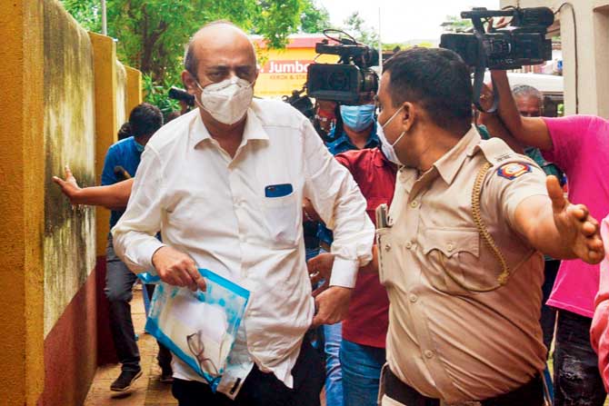 Chakraborty’s doctor father Indrajit fights media frenzy while being taken to the ED office from his residence, where he was questioned for six hours straight. PIC/GETTY IMAGES