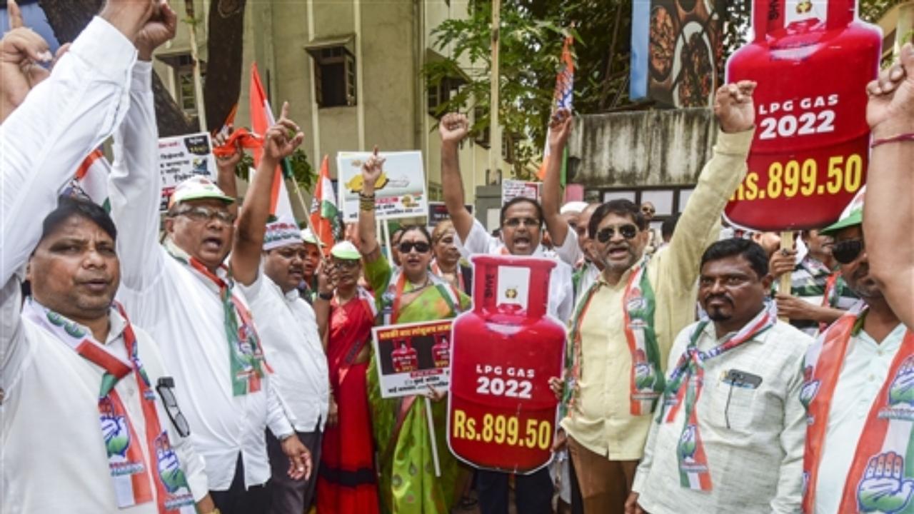 Congress workers raise slogans during a protest against the hike in prices of petrol, diesel and LPG cylinders. Pic/PTI