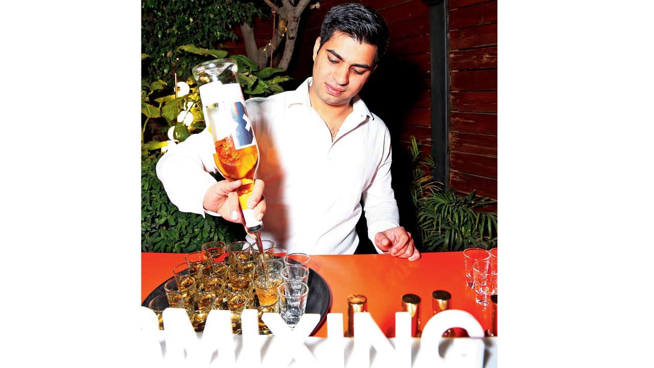 Shehan Minocher, brand ambassador of Moet Hennessy India, mixes a cocktail called India—a highball with tender coconut water, soda, honey water and lime juice