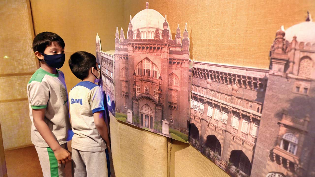 Kids look at miniature departments of the museum