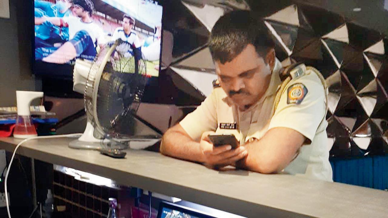 A police officer near the reception of an orchestra bar at 9.32 pm in Andheri East