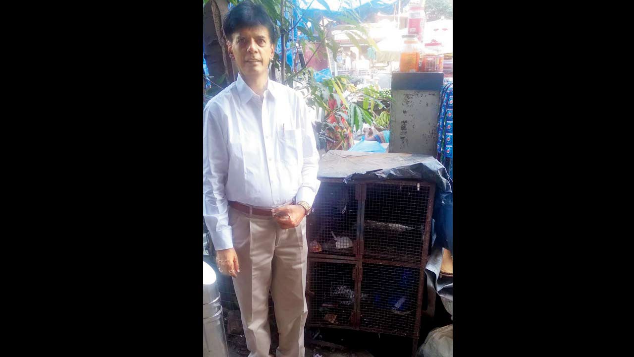 Sandip Shah with the cage outside his shop