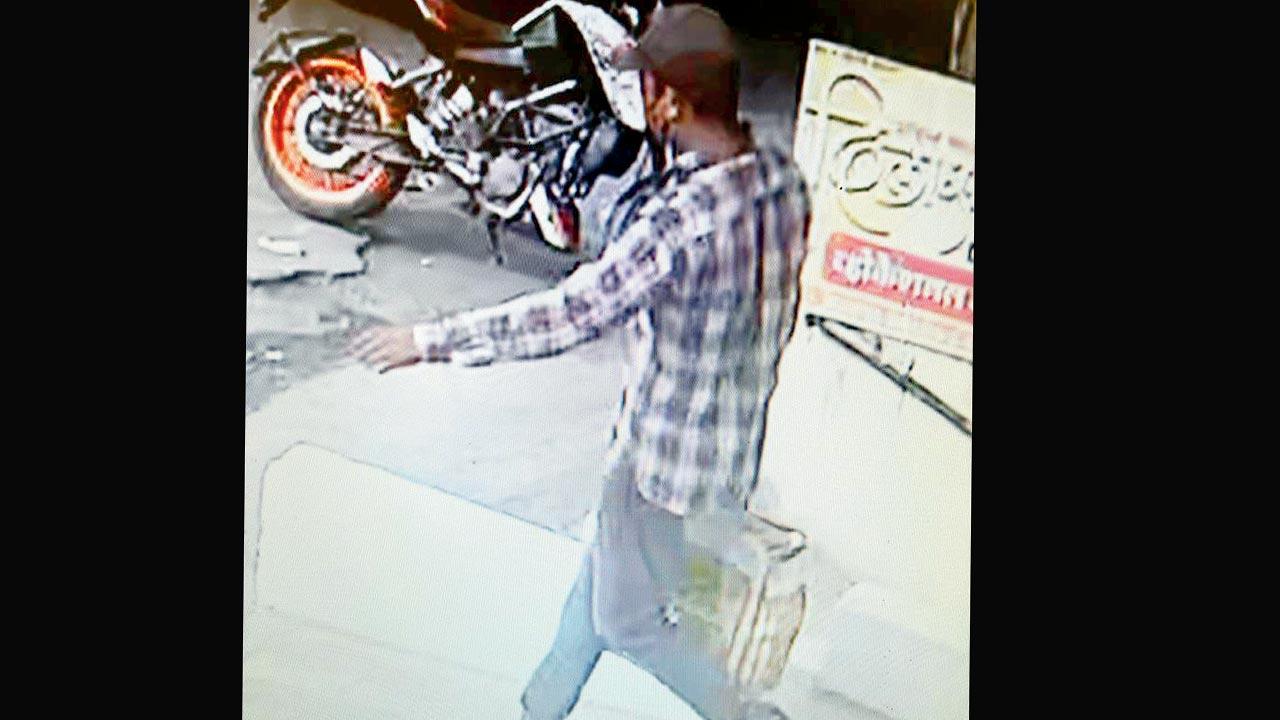 A screengrab from CCTV footage shows a burglar walking away with gold jewllery from a Pune store on March 25