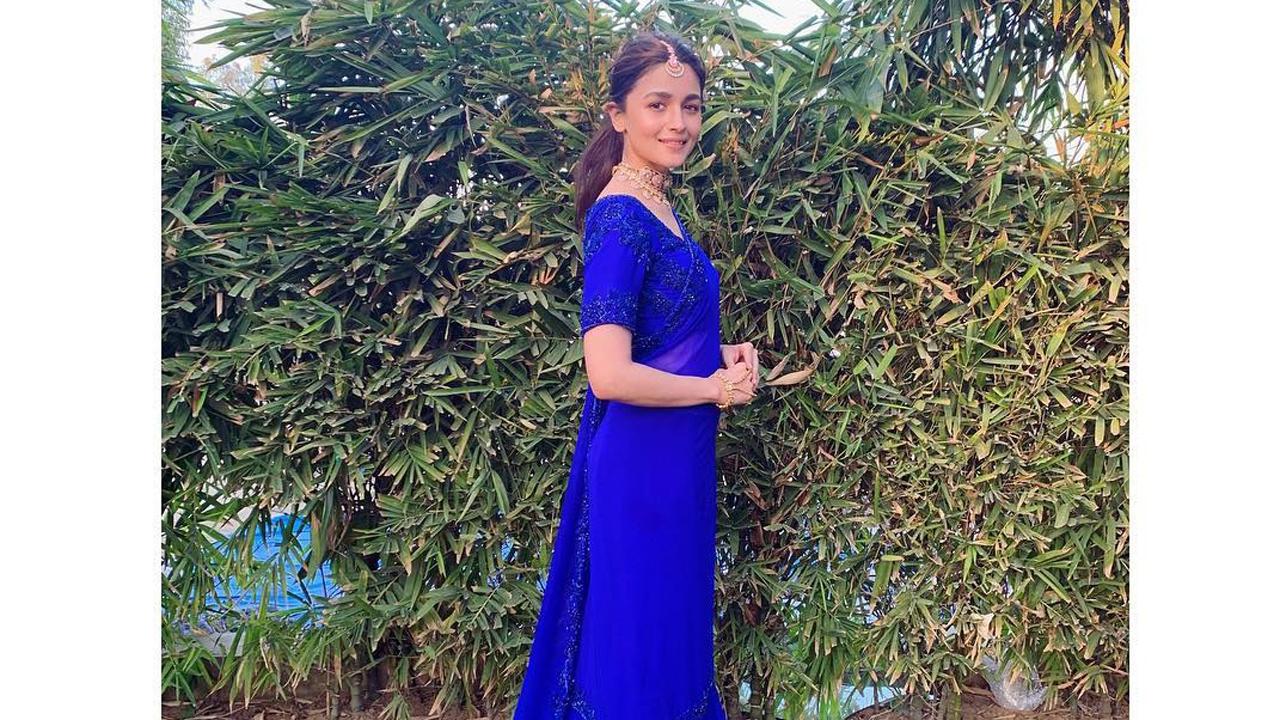 Alia opted for a royal blue sari, a combination of blue sharara pants and an elbow-length blouse and dupatta. The outfit has beadwork on the border. She accessorised the look with a maang tika, choker and wristlet.