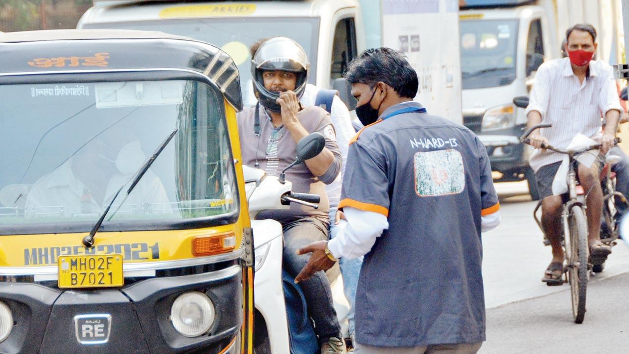 A mask marshal fines citizens for not wearing their masks inside public transport, on January 12. File pic