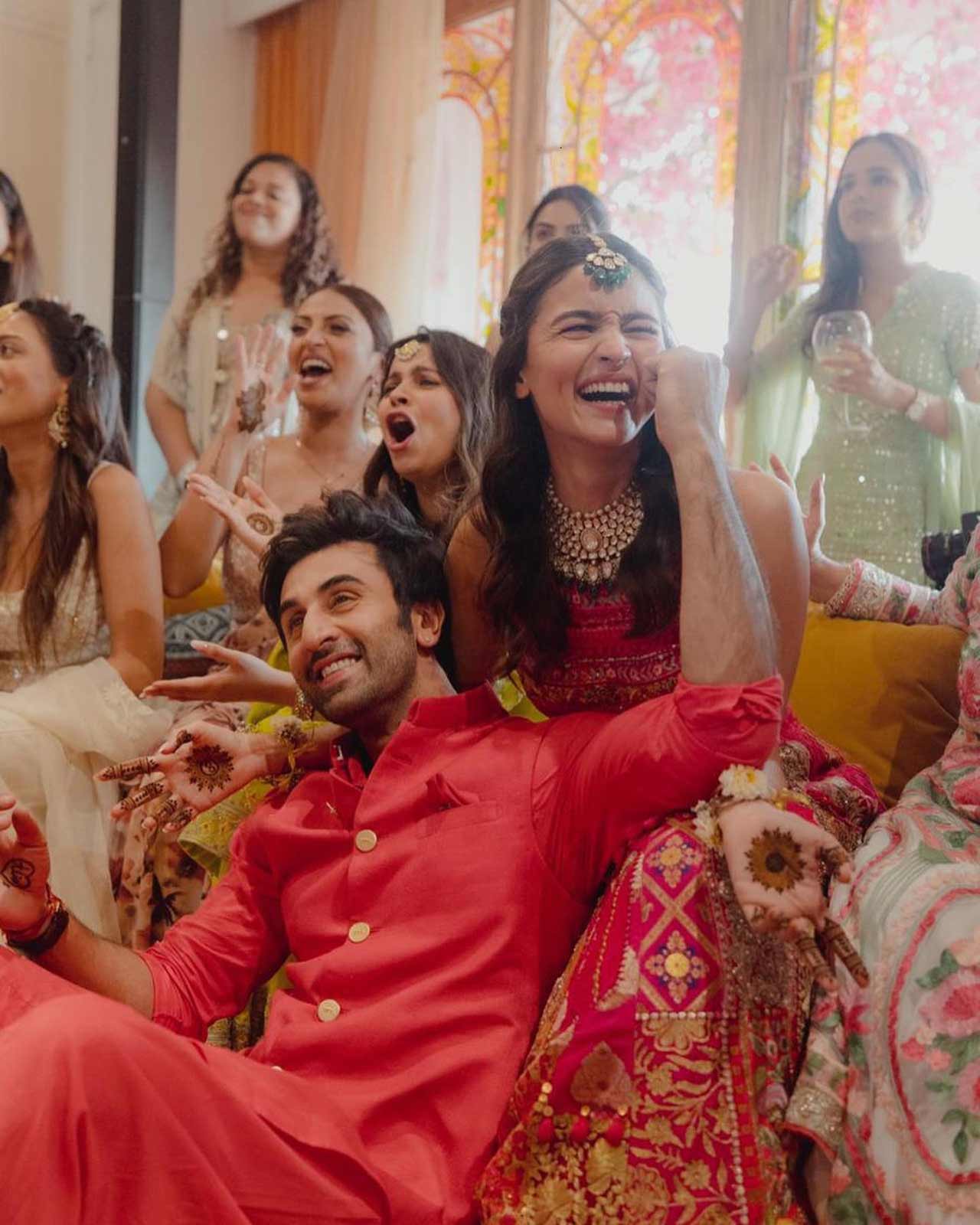 Next was an image of Ranbir Kapoor sitting in Alia Bhatt's lap while cutely pulling her cheeks. They were surrounded by guests invited to the Mehendi ceremony.