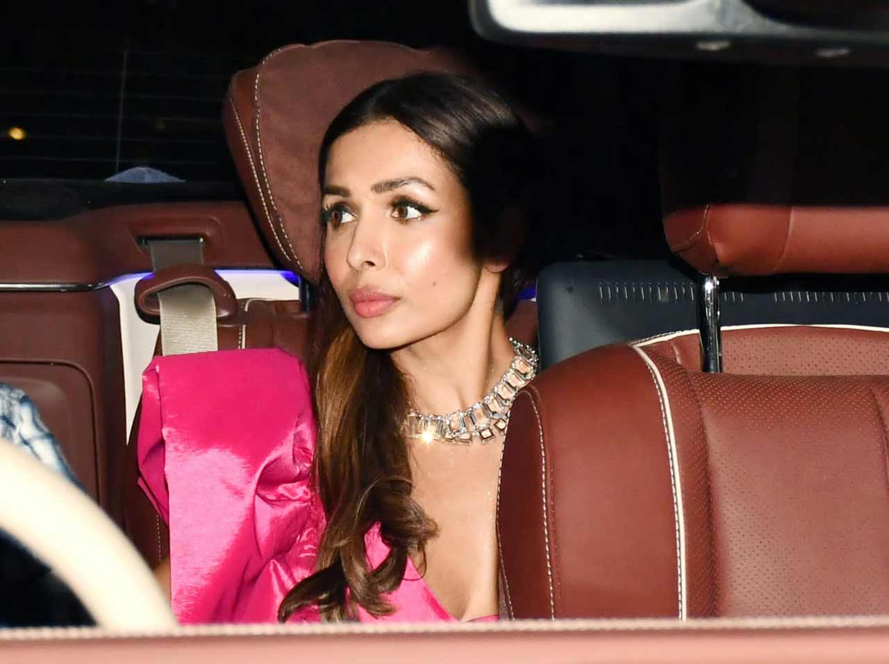 Malaika Arora stunned in a Fuschia pink outfit as she attended the bash with beau Arjun Kapoor.