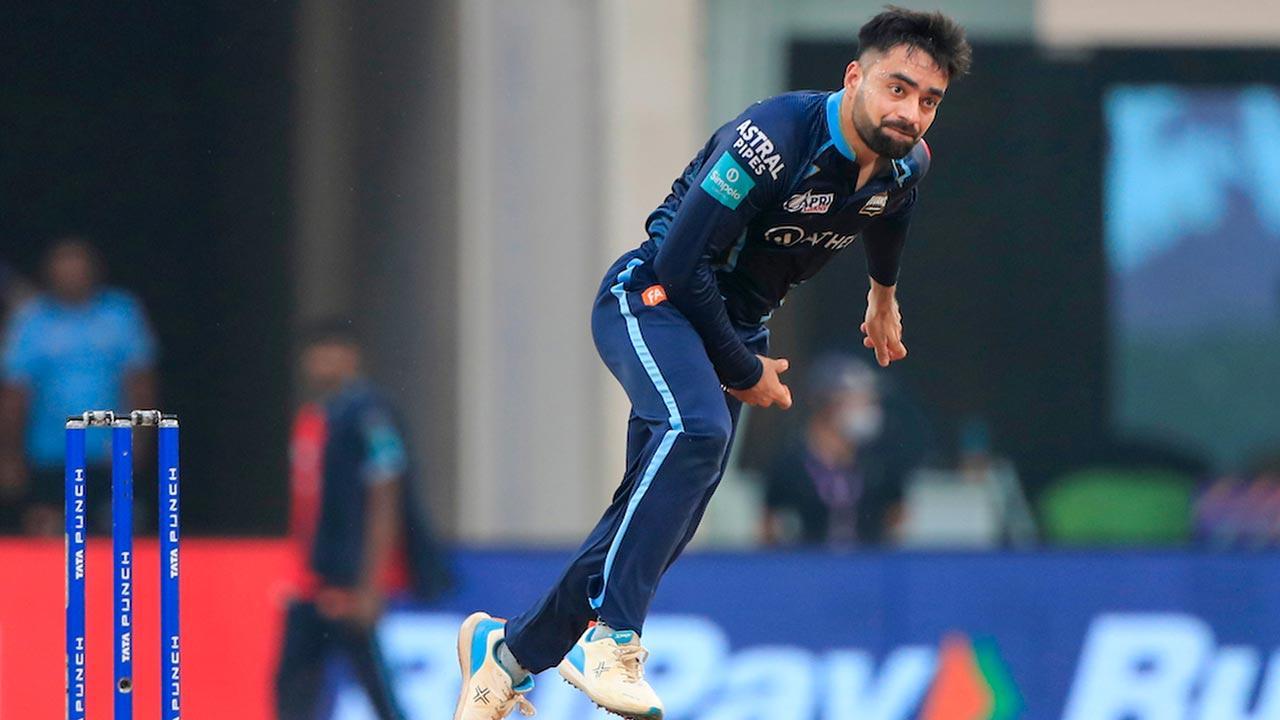 Rashid Khan of Gujarat Titans  bowls during T20 cricket match 35 of the Indian Premier League 2022 (IPL season 15) between the Kolkata Knight Riders and the Gujarat Titans, at the DY Patil Stadium in Mumbai. Pic/PTI