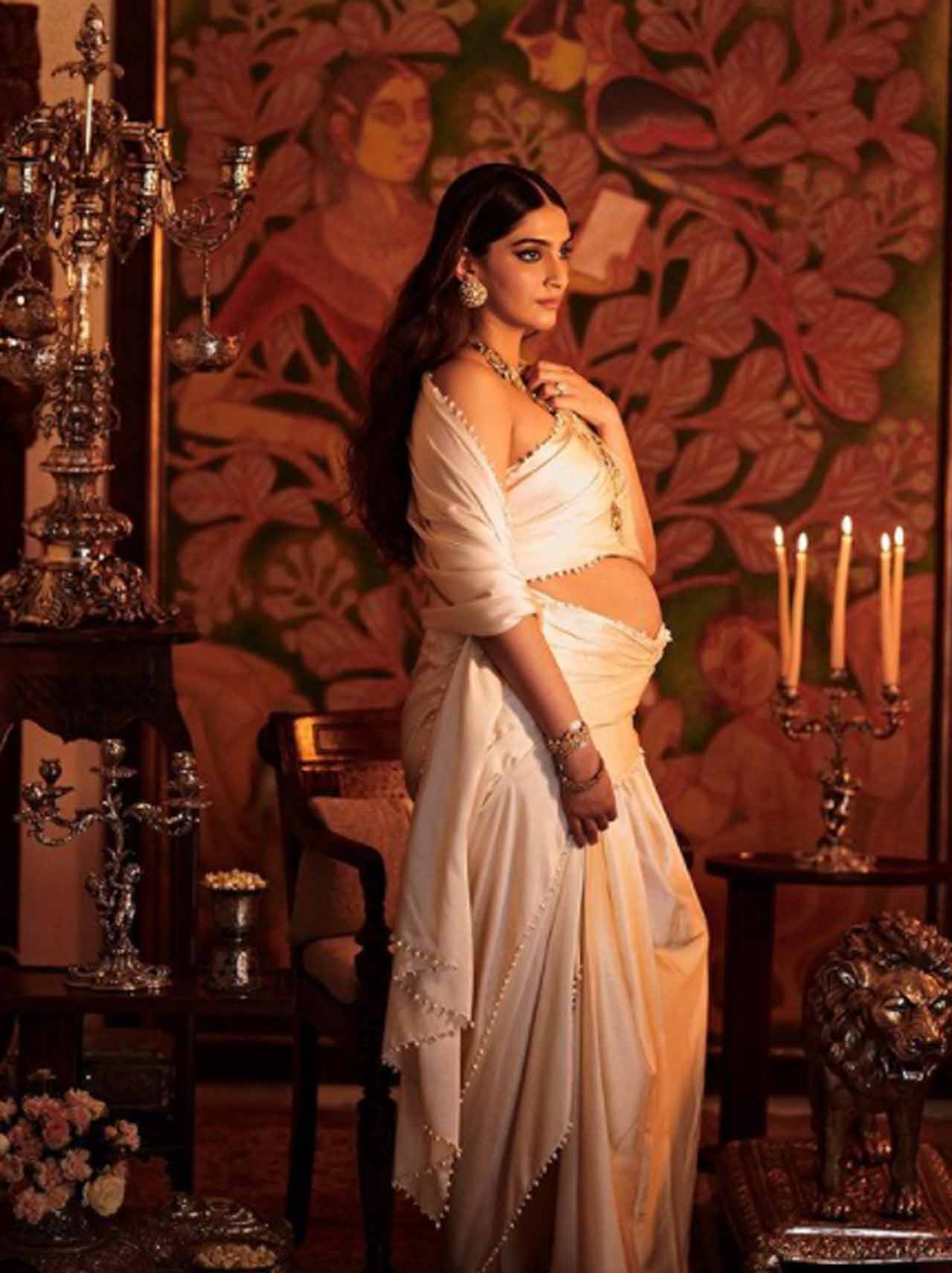 Sonam looked straight out of a painting, flaunting her baby bump in an ivory-toned draped skirt saree, paired with a tube blouse. She complimented her delicate outfit with heavy gold jewellery and finished the dramatic look with smokey eyes and naturally-styled long hair.