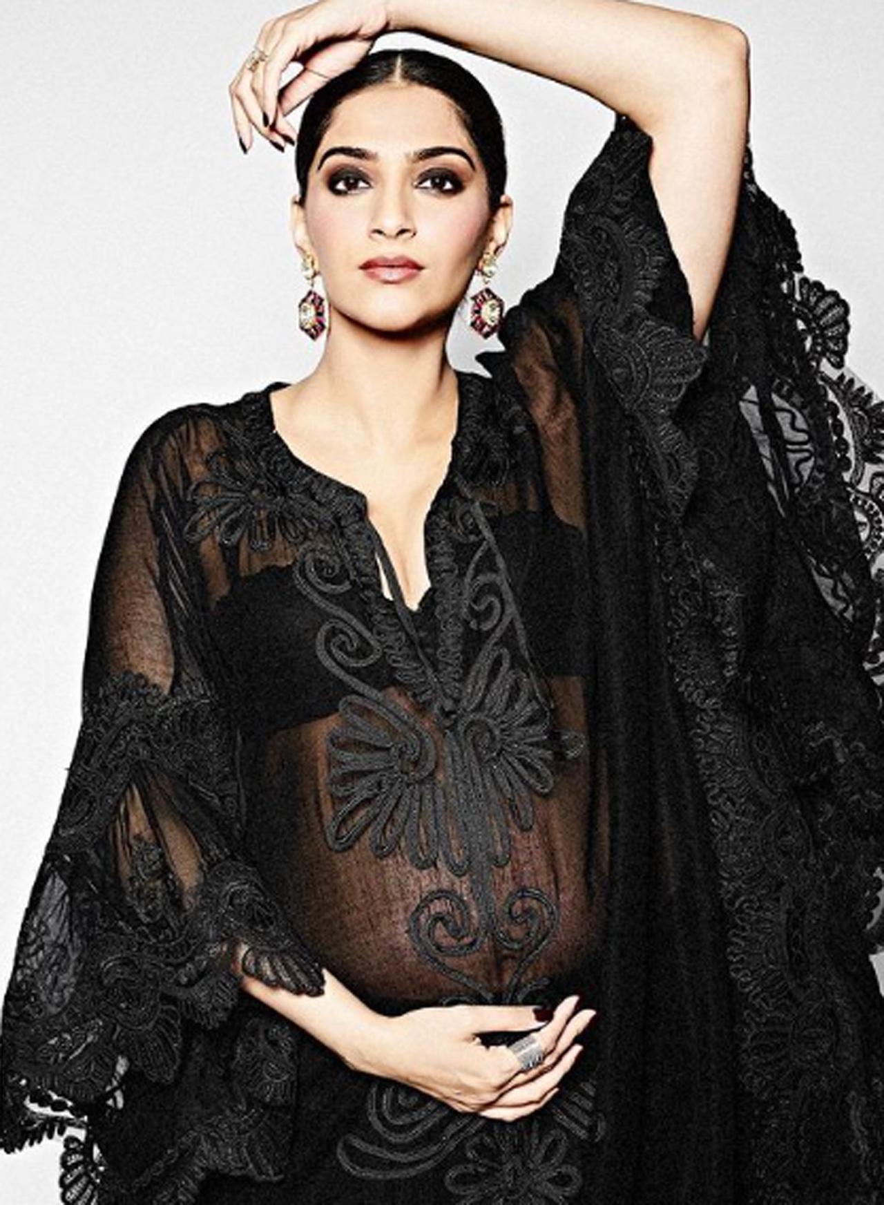 Showing off her beautiful maternity look, Sonam looked glamorous as ever as she held her baby bump with one hand while gently placing the other on her head.