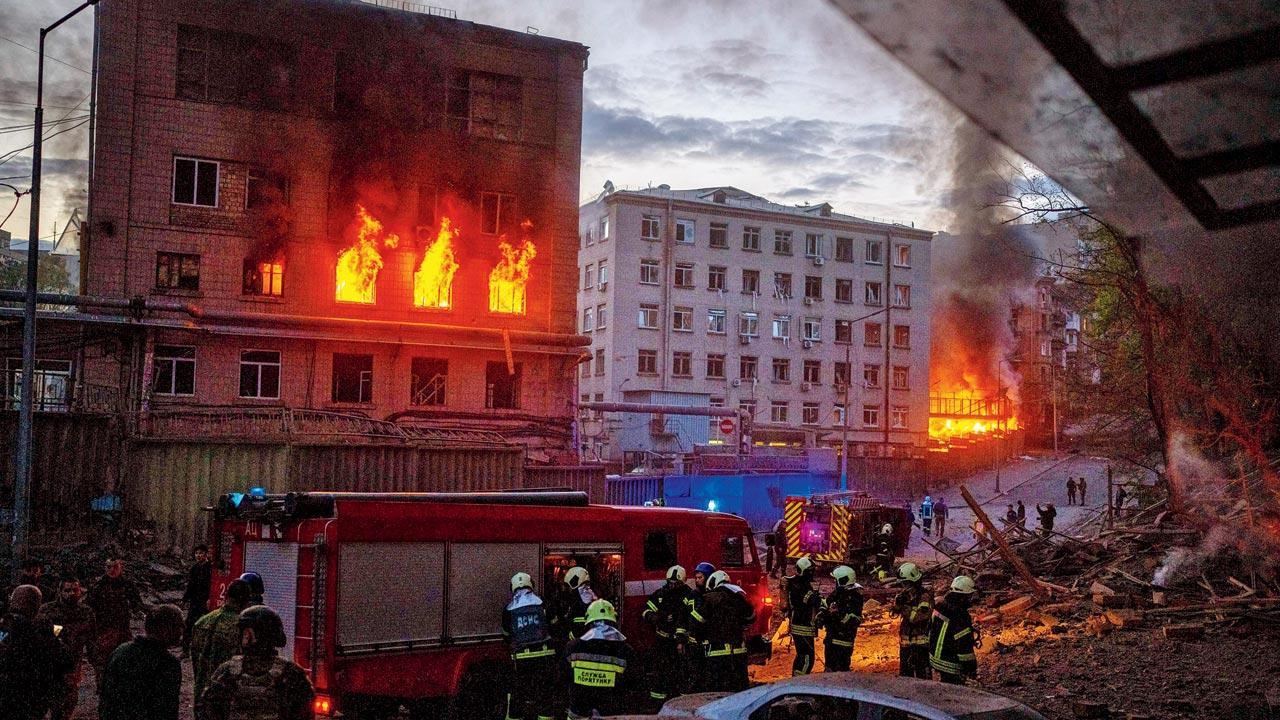 Emergency services personnel at work following an explosion in Kyiv, Ukraine on Thursday when Russia struck  shortly after a meeting between President Volodymyr Zelensky and U.N. Secretary-General Antonio Guterres. Pic/AP