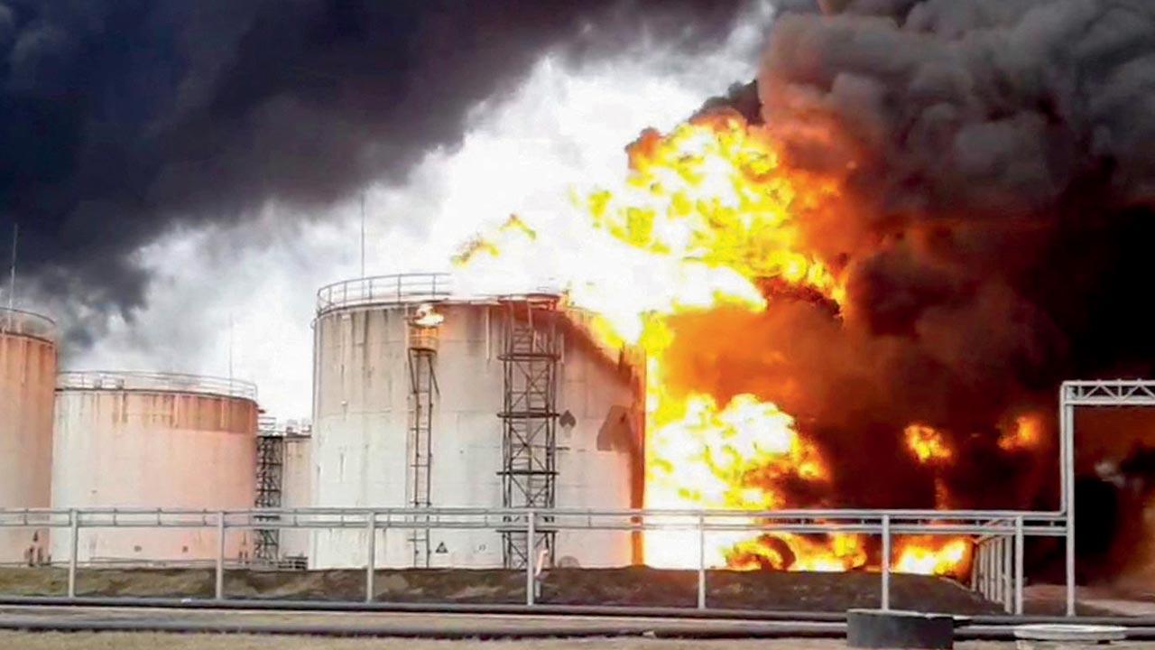 Firemen work to extinguish a fire at a Rosneft fuel depot in Belgorod in Russia on Friday. Pics/AP, AFP