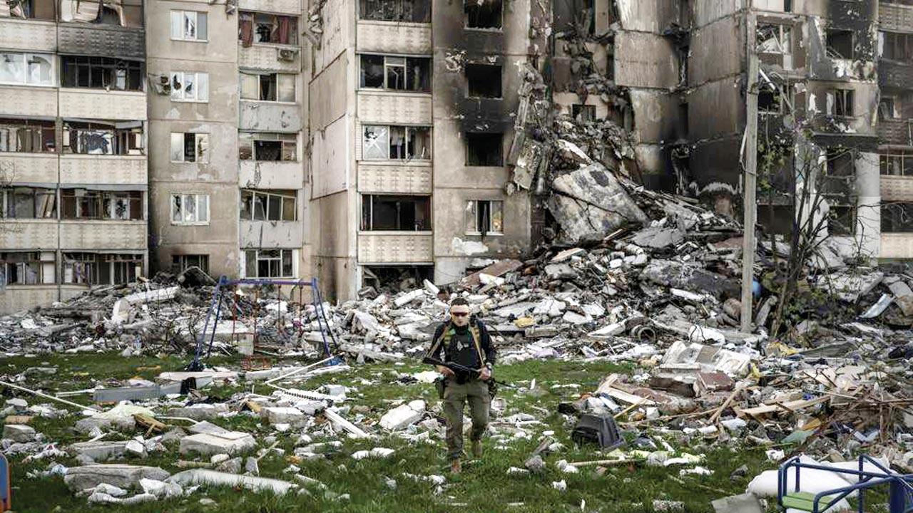 A Ukrainian serviceman walks amid the rubble of a building heavily damaged by multiple Russian bombardments in Kharkiv on Monday