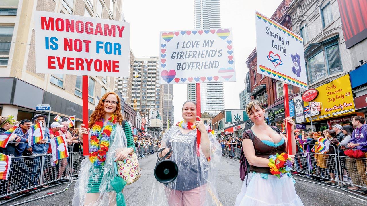 A pro-polyamory group marches with placards during the Toronto LGBTQ Pride Parade. Pic/Getty Images