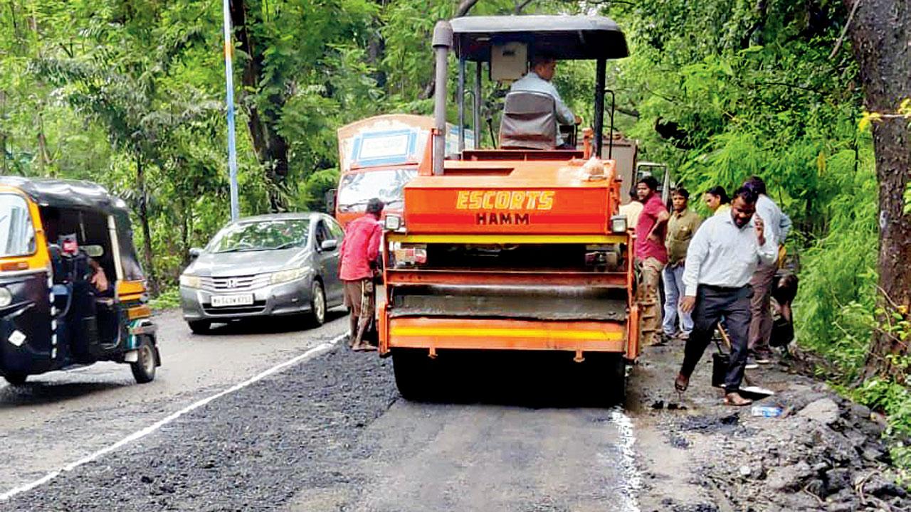 BMC workers fix the main road at Aarey Milk Colony. Motorists have been complaining about the poor road conditions in the area