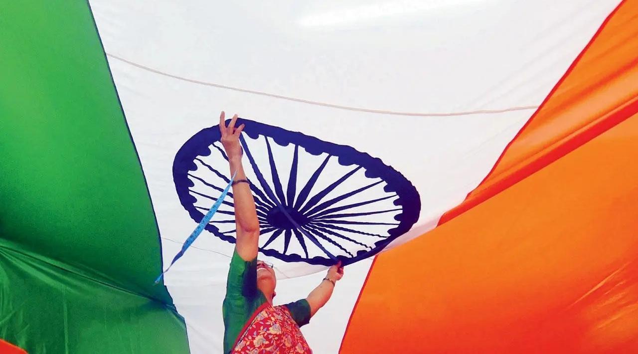 Tricolour trials: A woman measures the National Flag ahead of Independence Day at a workshop in Byculla. Pic/Shadab Khan