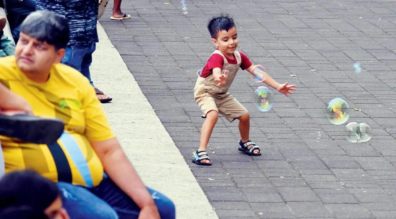 Pop it: Ignoring the sea view, a young boy on Marine Drive is busy trying to pop soap bubbles. Pic/Ashish Raje