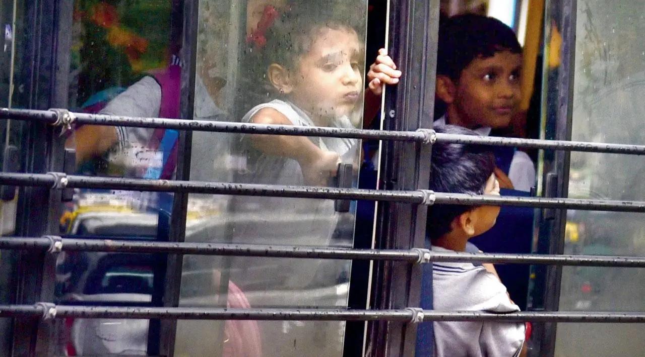 It’s hard to put on a happy face: A young girl sulks as she looks out the window with fellow students of Little Angels’ School on their bus in Sion. Pic/Atul Kamble