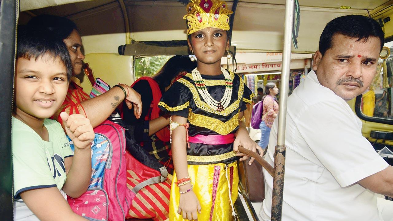 A child dressed as Lord Krishna travels in an auto in Dahisar. Pic/Atul Kamble