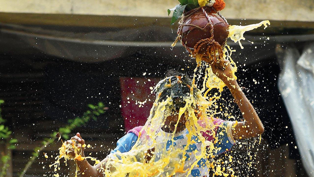 A boy smashes the dahi handi with his head at Khandke building galli, Dadar. Pic/Ashish Raje