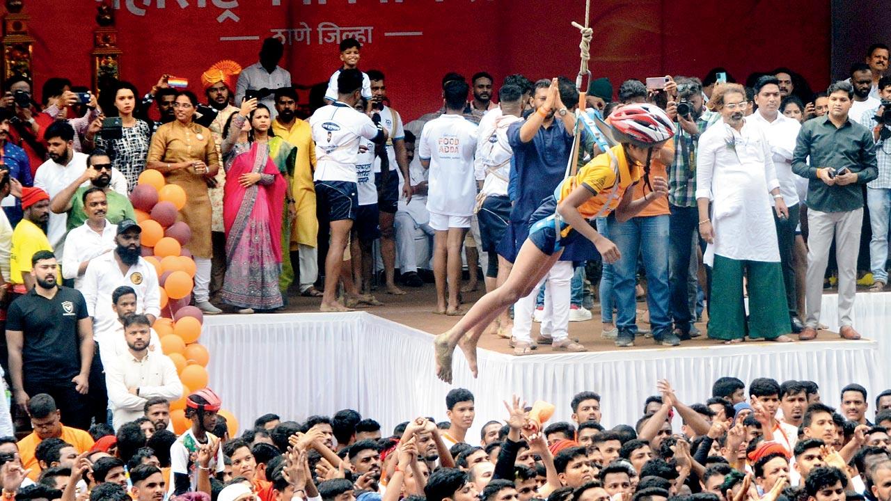 A boy who was at the topmost rung of the pyramid is left hanging from the harness, at Naupada in Thane. Pic/Satej Shinde