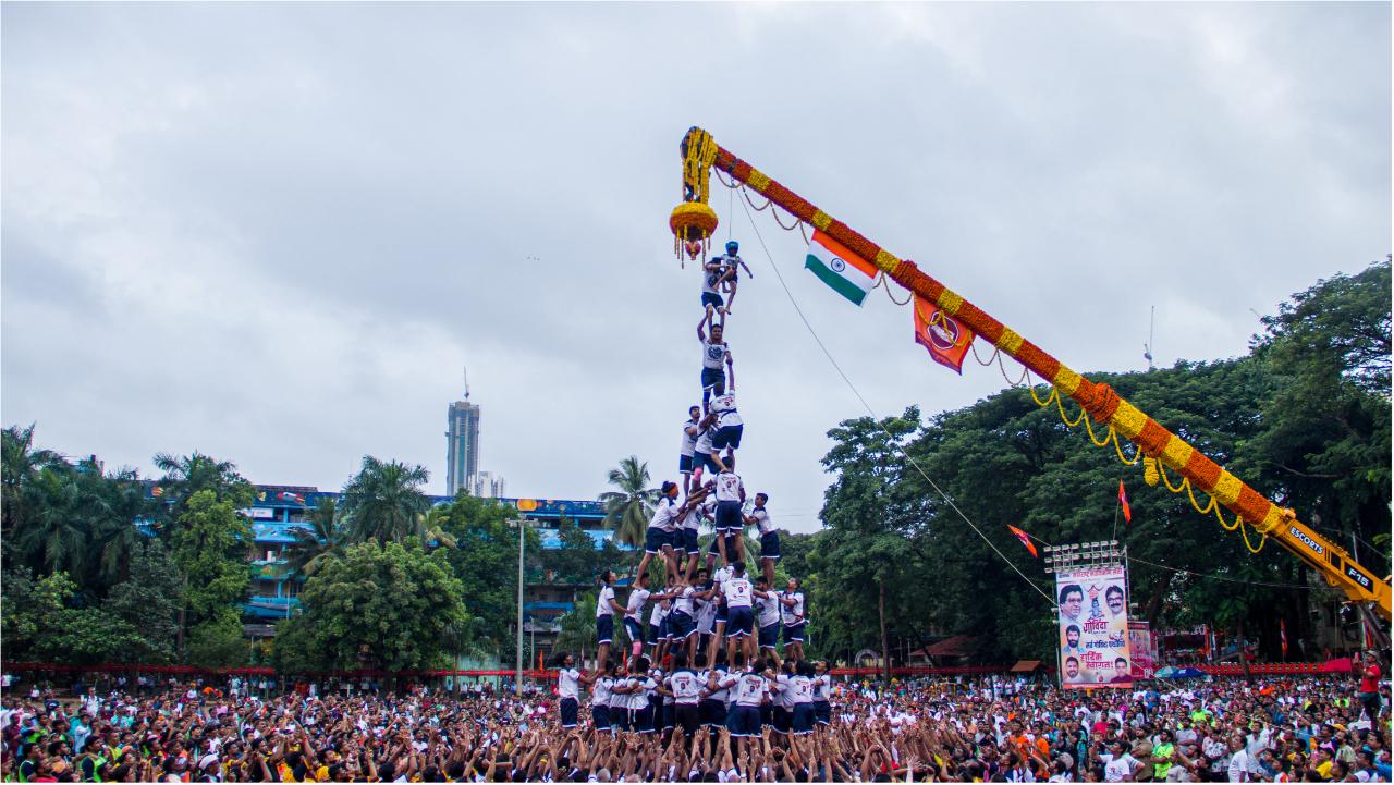 A group tries to break a Dahi Handi in Mumbai's Kalachowki area in Parel with an overcast sky, as people came out for the first time in two years to celebrate the festival of Janmashtami. Photo Courtesy: Abhishek Satam