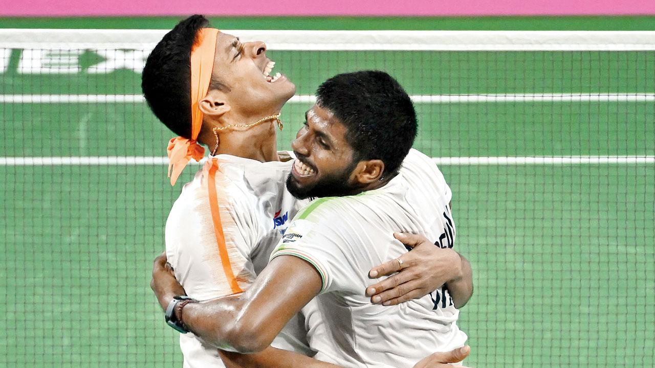 Satwik Rankireddy (right) and Chirag Shetty celebrate beating England’s Ben Lane and Sean Vardy in the men’s doubles final