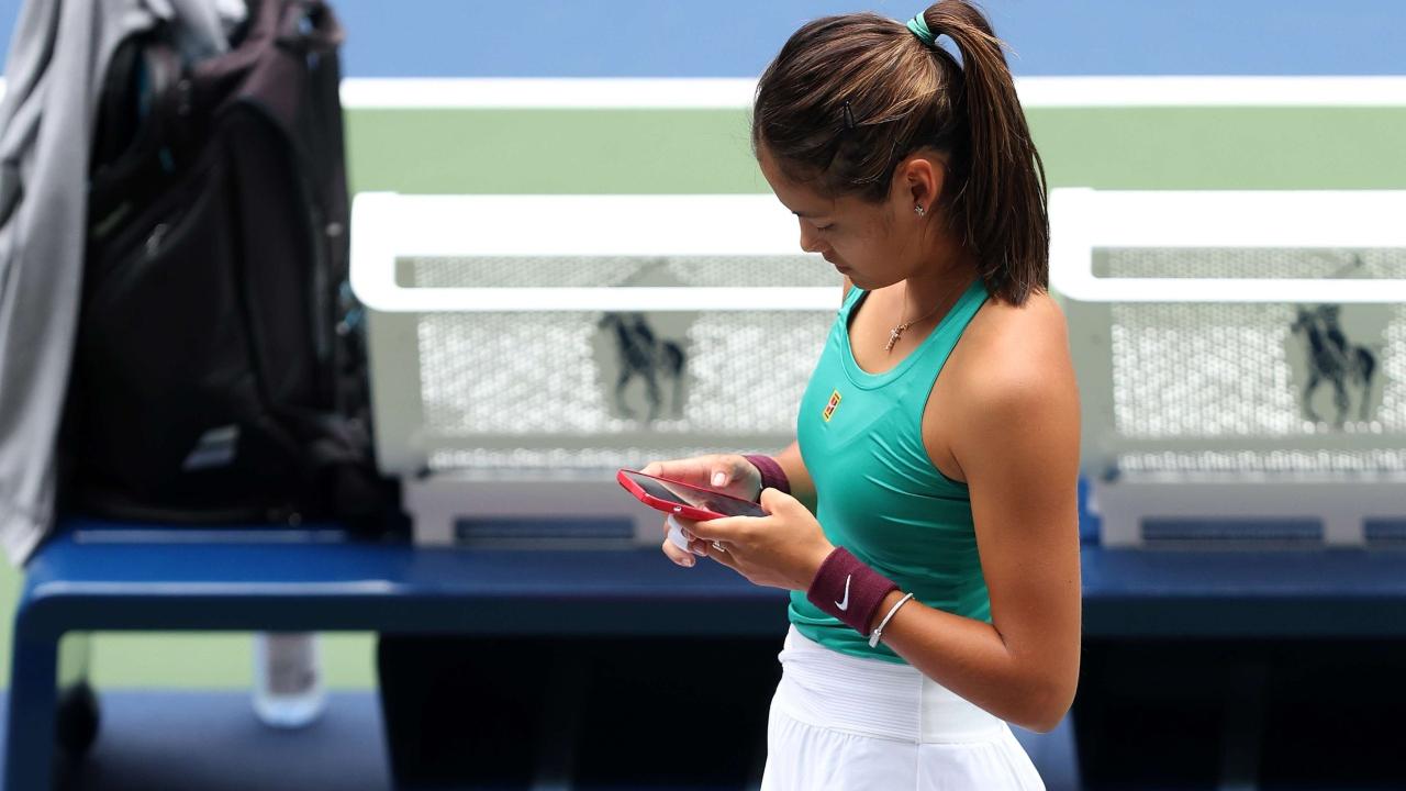 Emma Raducanu is busy on her phone ahead of the US Open 2022. Photo - AFP/Getty Images
