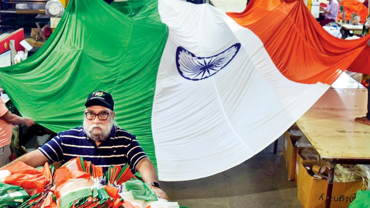 Flag Company in Naigaon has taken on bulk orders of machine-made polyester flags of India for the Har Ghar Tiranga campaign as part of the Azadi Ka Amrit Mahotsav. Managing director of the company, Amarjit Singh Negi, seen here with the finished products ready for dispatch. Pic/Atul Kamble