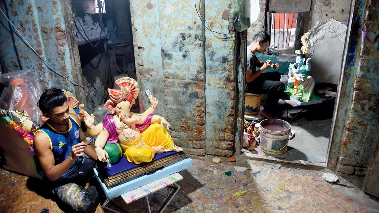 A sculptor gives finishing touches to a PoP idol at a workshop in Hamrapur, Pen. Pics/Sameer Markande