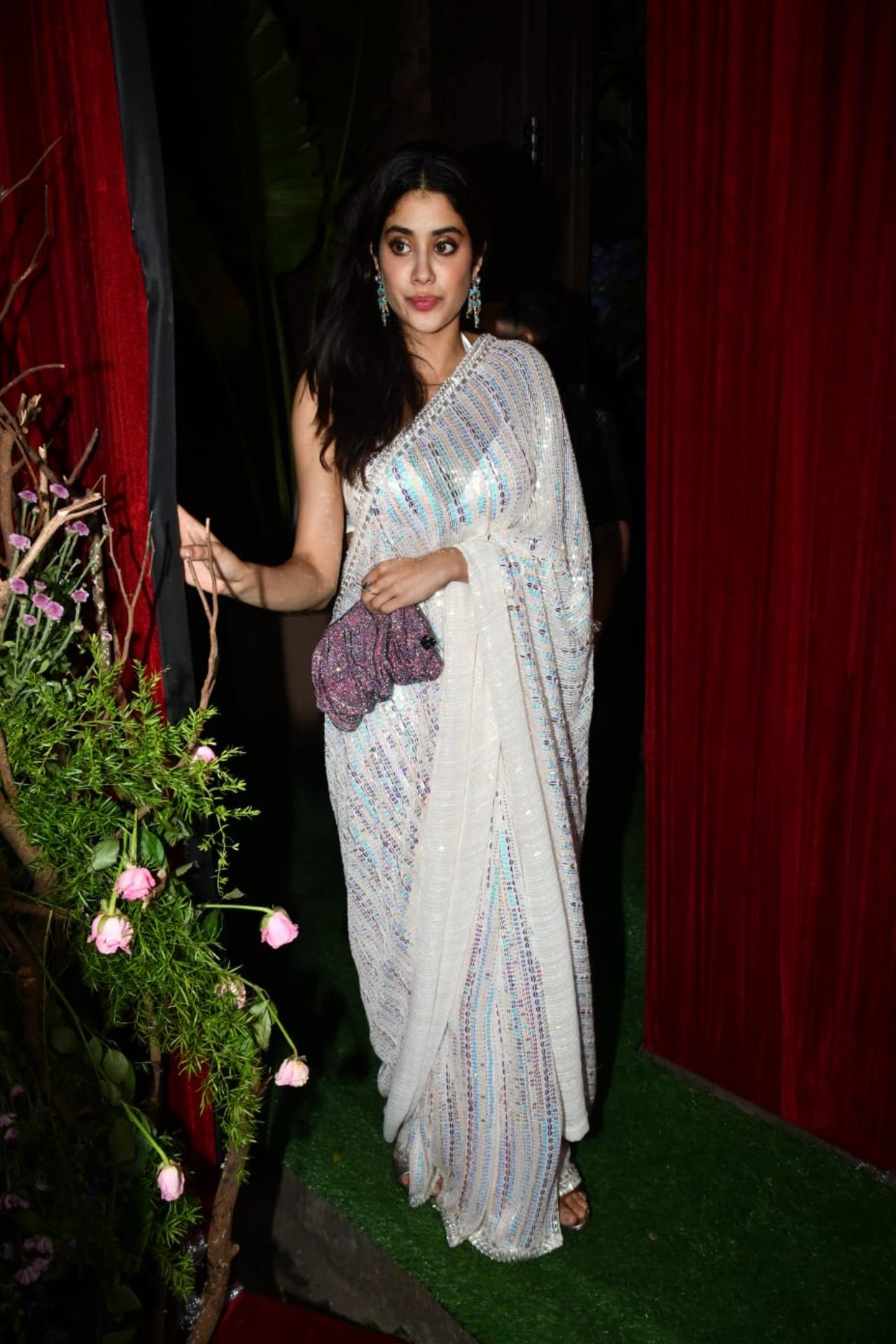 Janhvi Kapoor looked gorgeous as ever in a shimmery white saree with a backless blouse