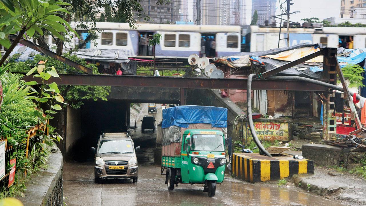 Vehicles pass through Malad subway as water clears, on Tuesday. Pic/Anurag Ahire