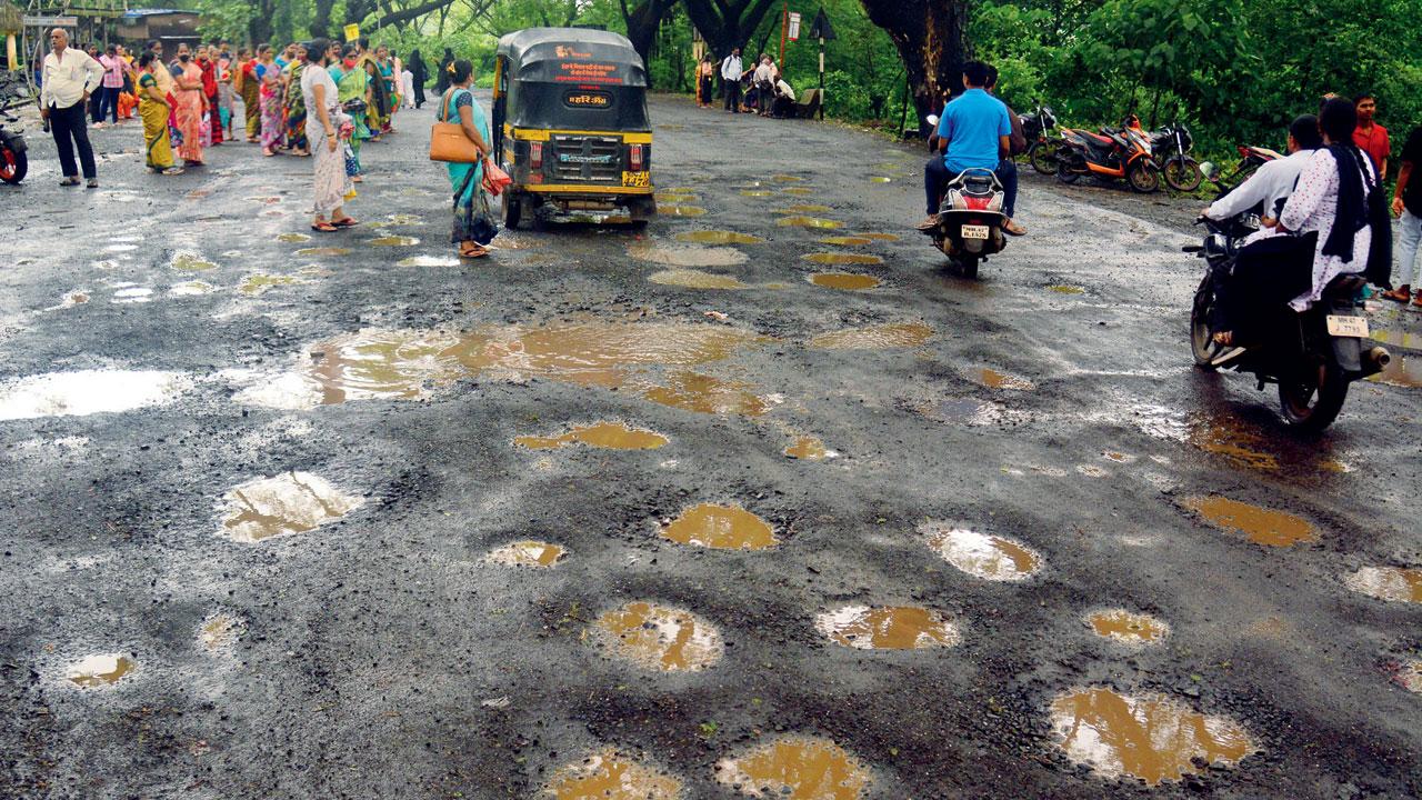 Potholes on the road near Aarey Dairy in Aarey Milk Colony. Pics/Shadab Khan