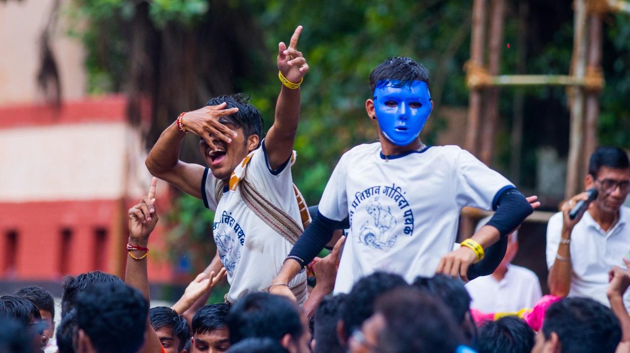 Boys who are part of a pathak that breaks the Dahi Handi in Dadar, dance to the tunes of the music as their friends surrounding them enjoy the Janmashtami festivities after two years. Photo Courtesy: Abhishek Satam