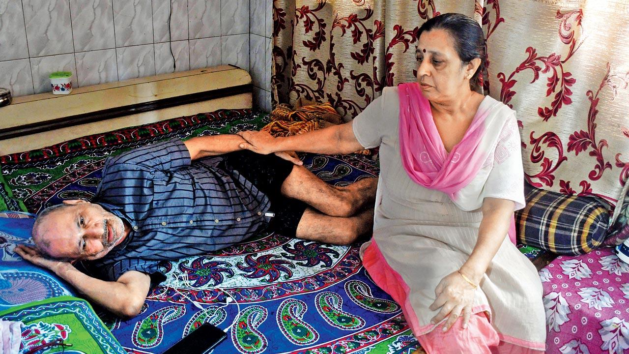 Suman Kochad with her paralysed husband at their 3rd-floor home in building no. 5